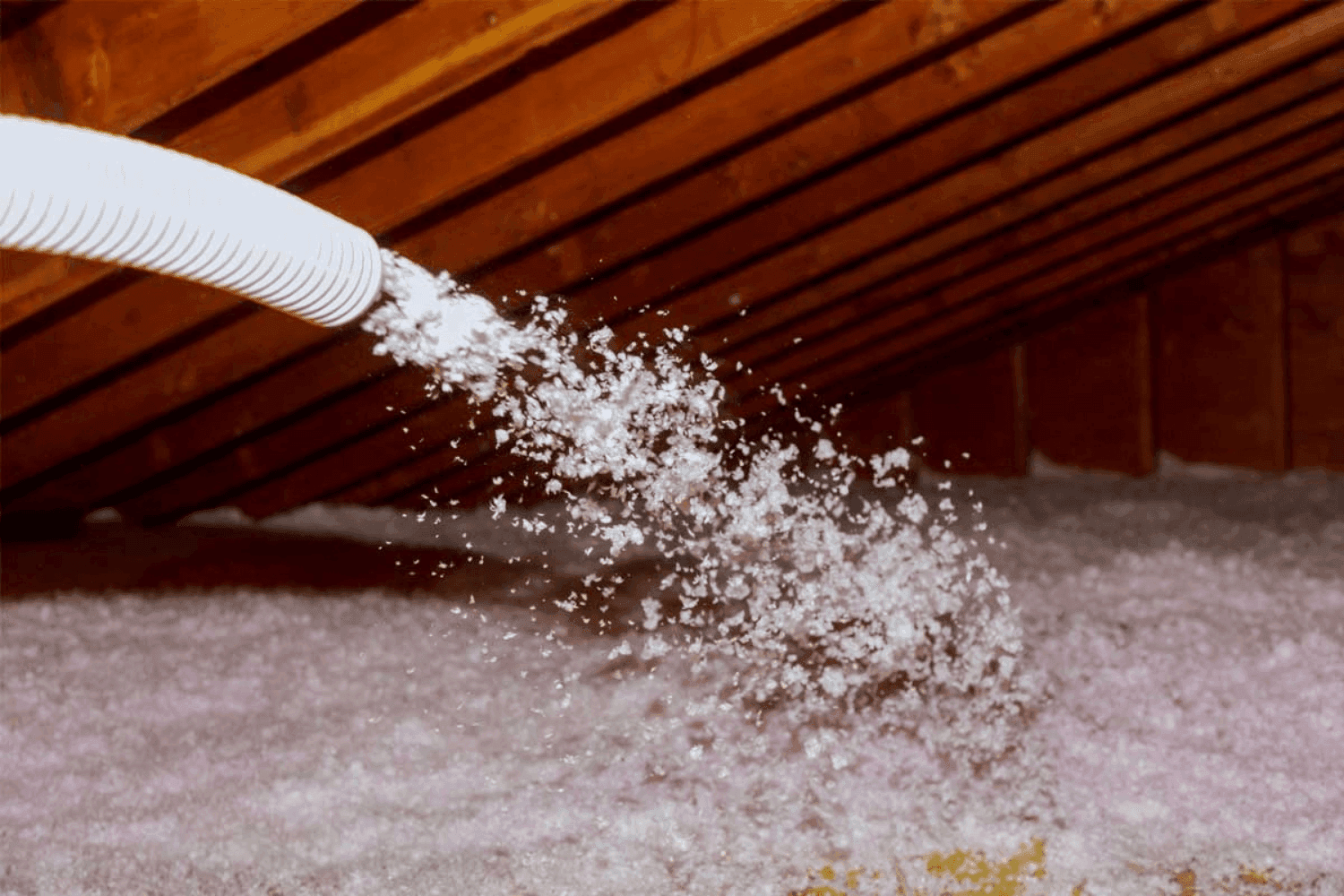 Blown-in insulation being installed in an attic