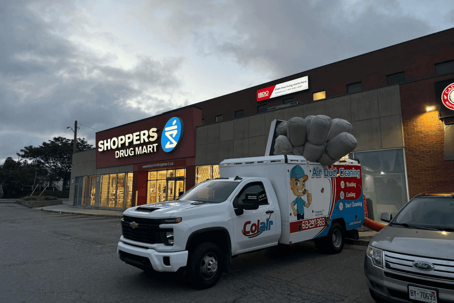 Colair service truck parked at a commercial plaza in Ottawa