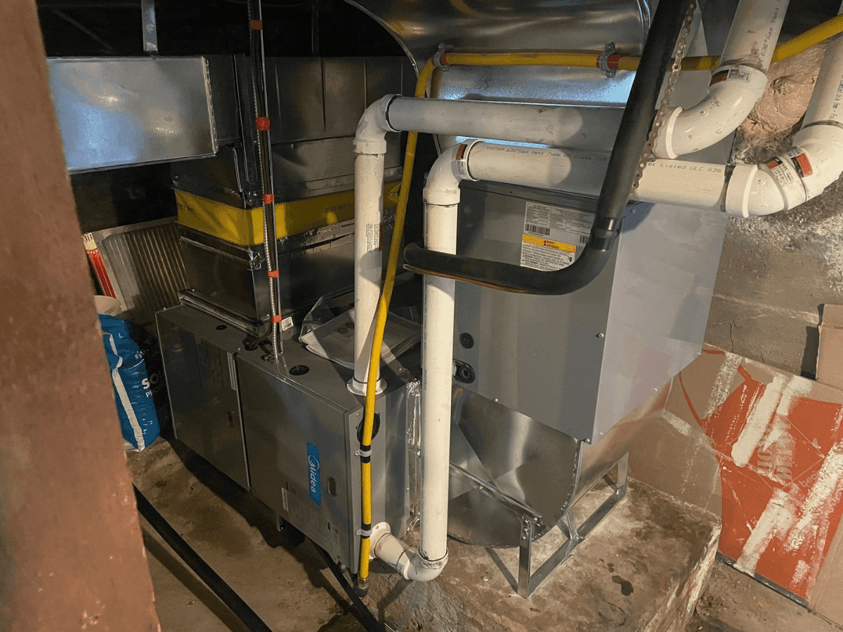 Newly installed high-efficiency furnace with venting in a basement