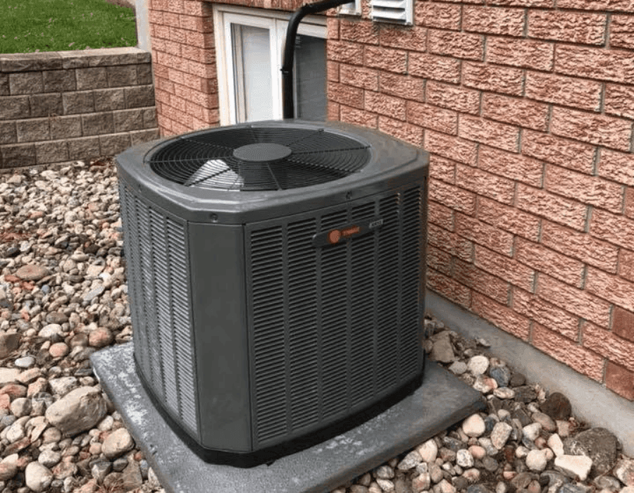 Central air conditioner condenser unit outside a home