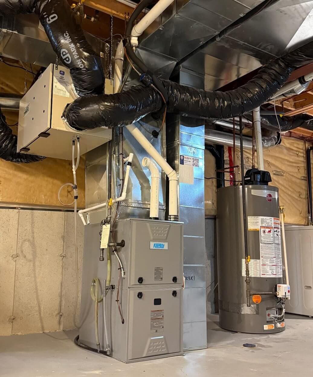 Newly installed high-efficiency furnace with ductwork and air exchanger in an Ottawa basement