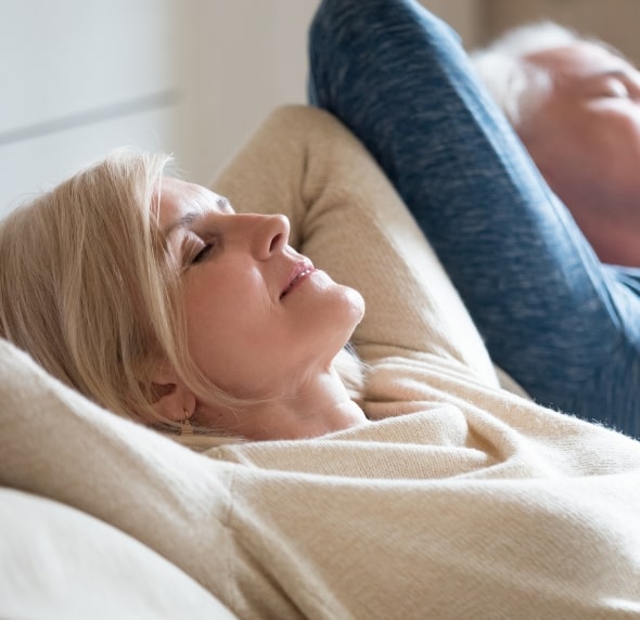 old couple relaxing in home